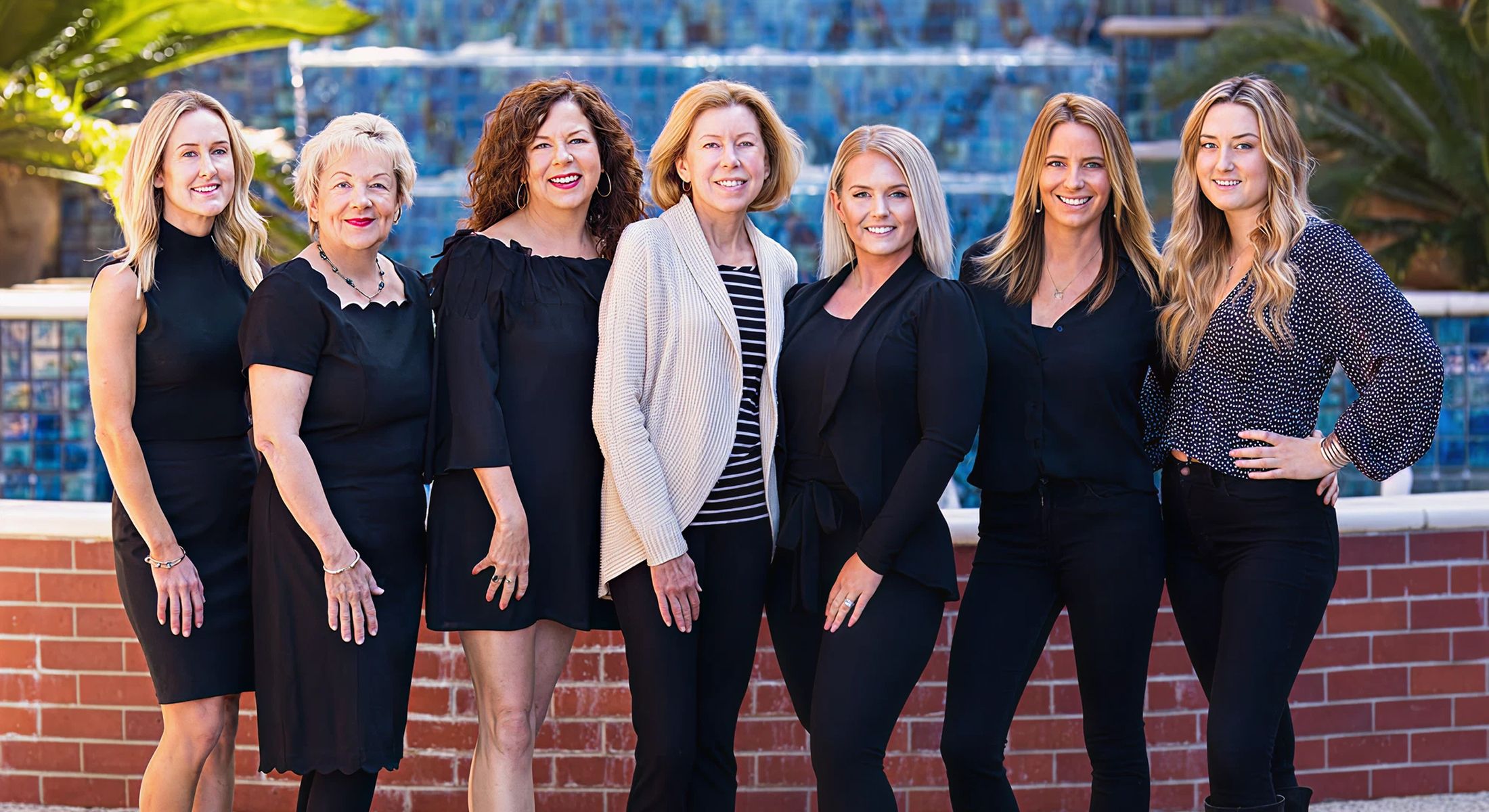 Group of women posing together outdoors.