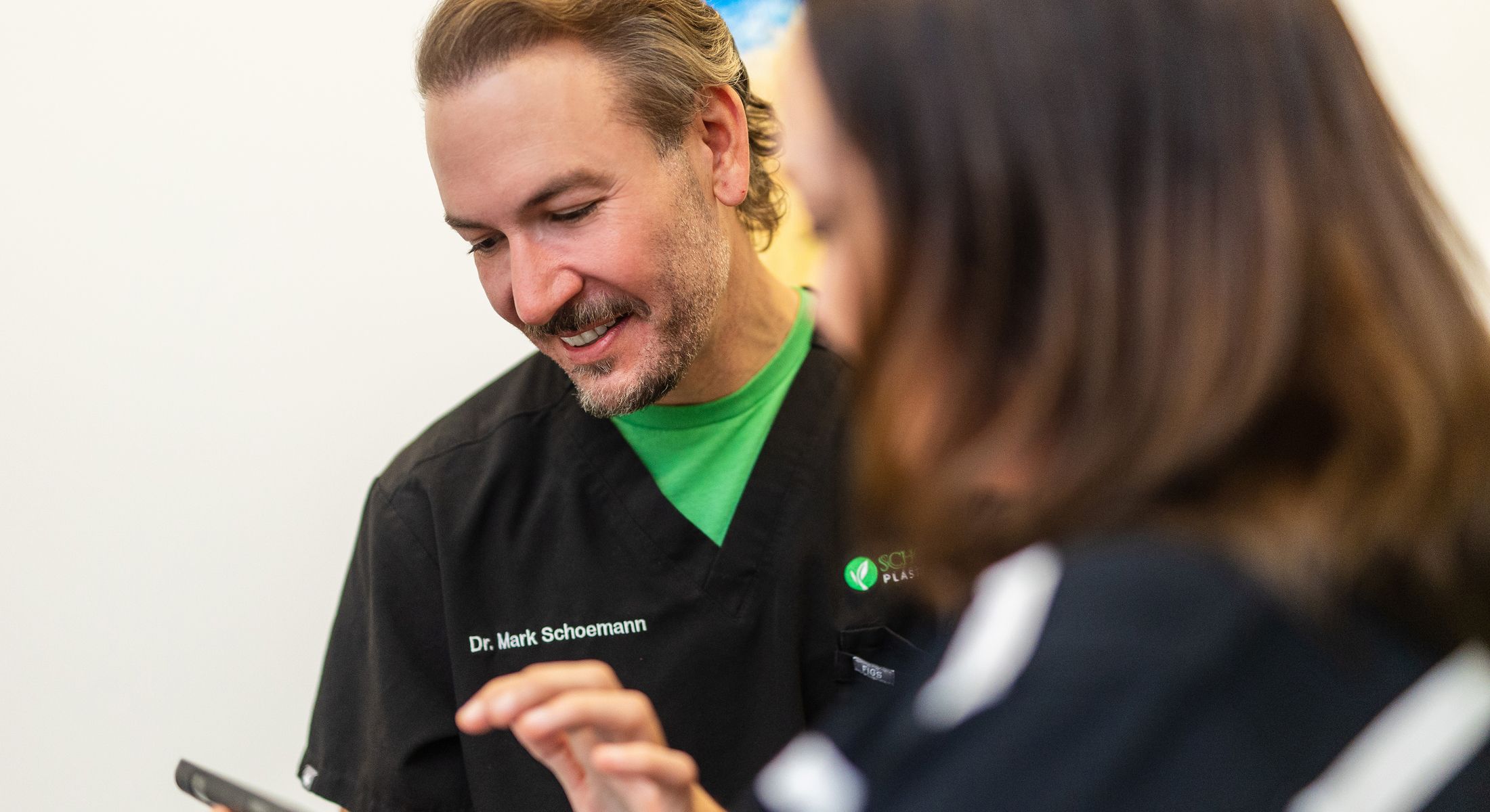Doctor consulting with a patient using a phone.