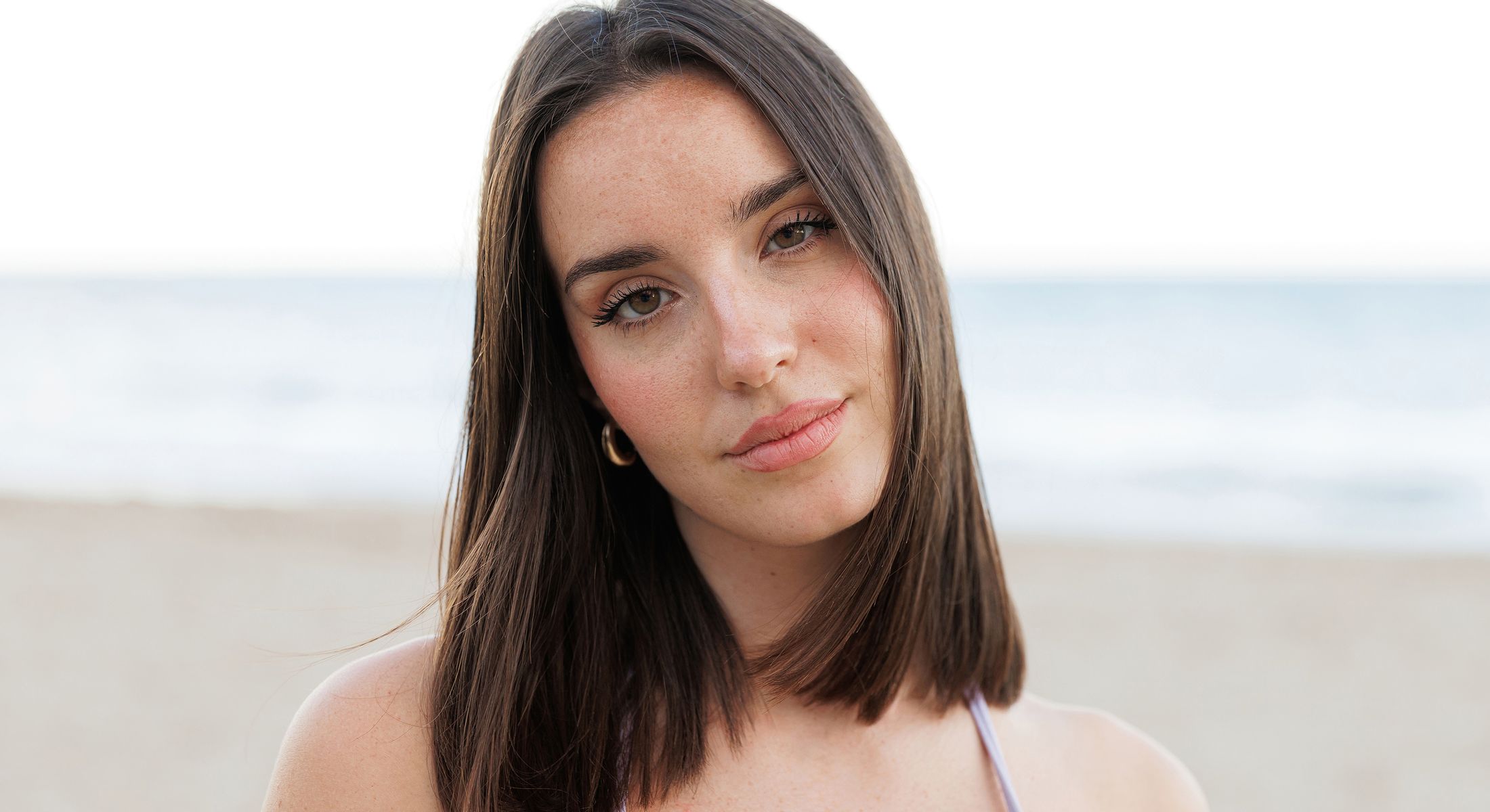 Encinitas double chin removal model with long hair by the beach.